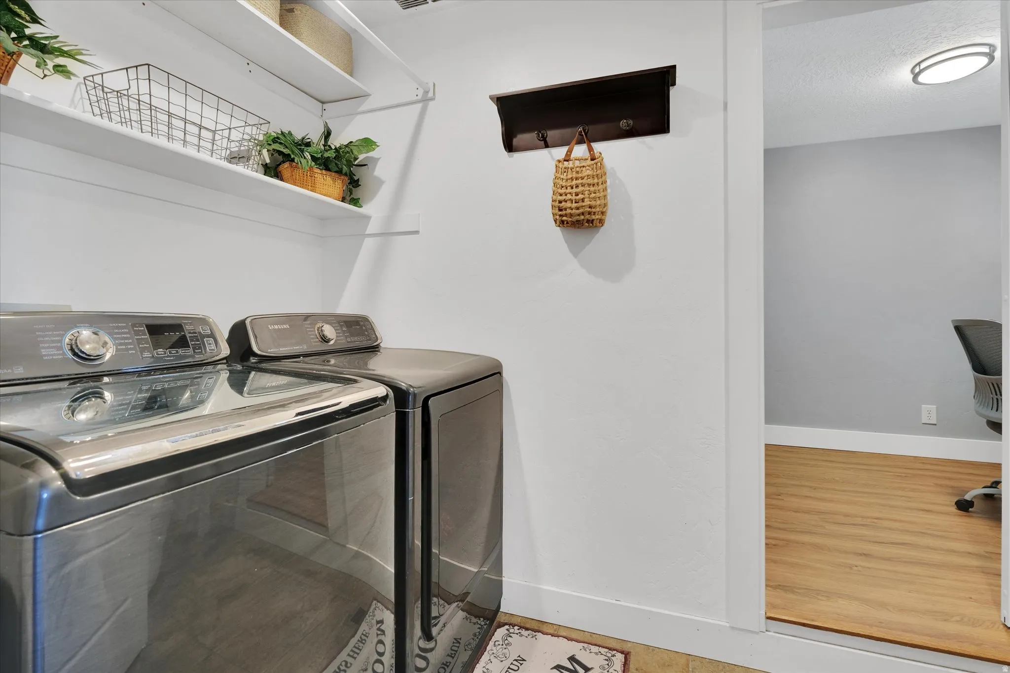 Wall-mounted shelving system, dark wood-finish coat rack, and wood-finish flooring