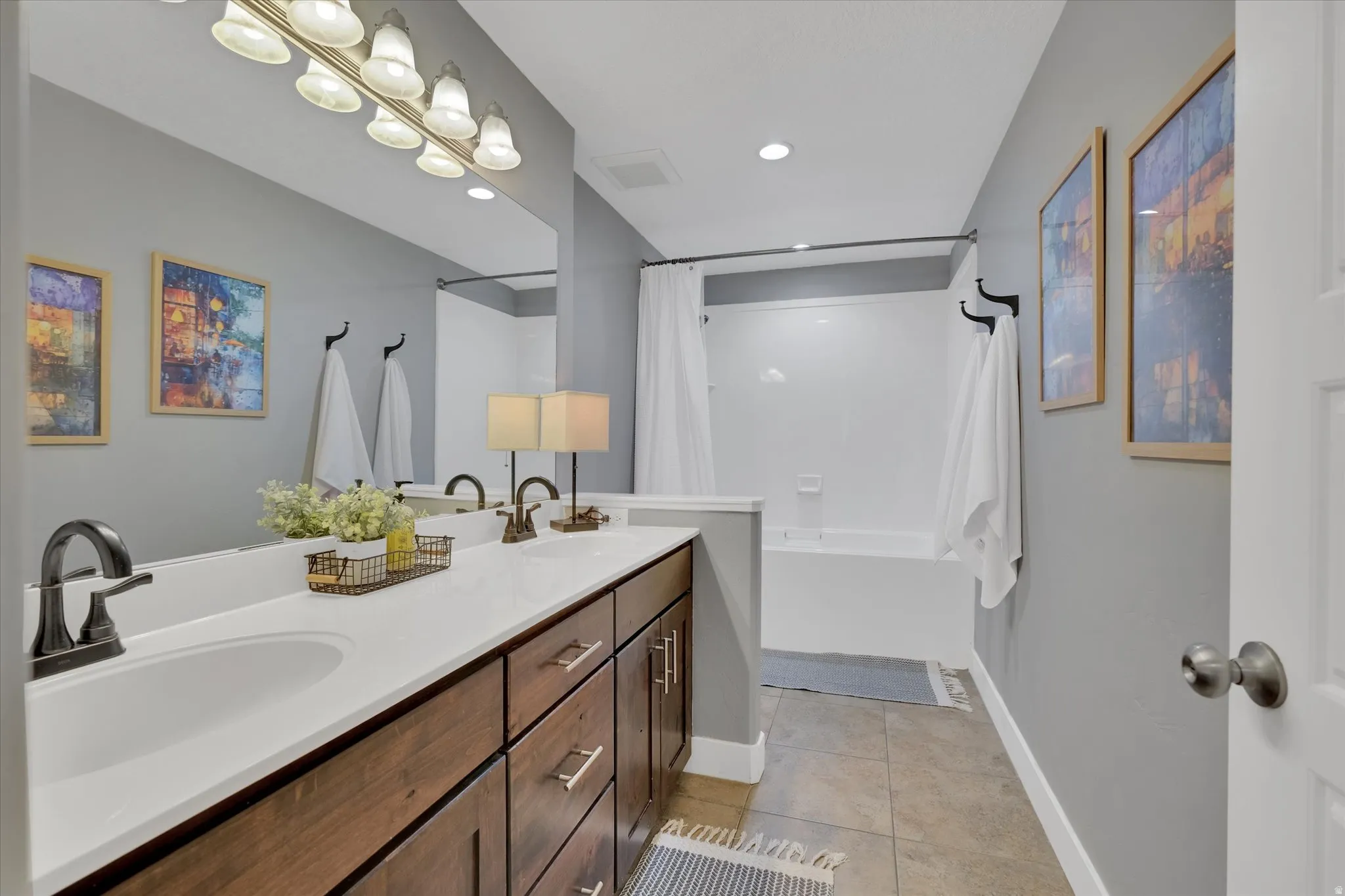 Dual vanity with wood-finish cabinetry and undermount sinks