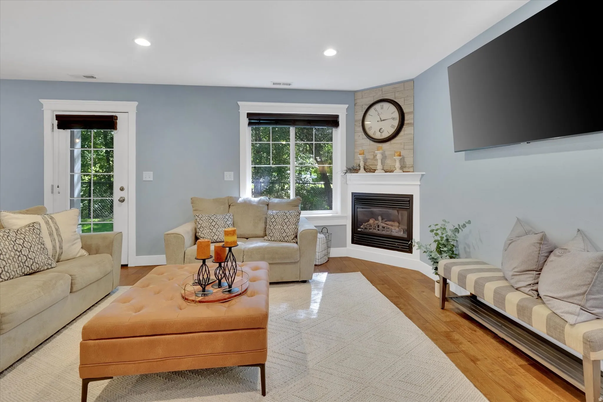 Corner fireplace with stone-clad surround and classic white mantel
