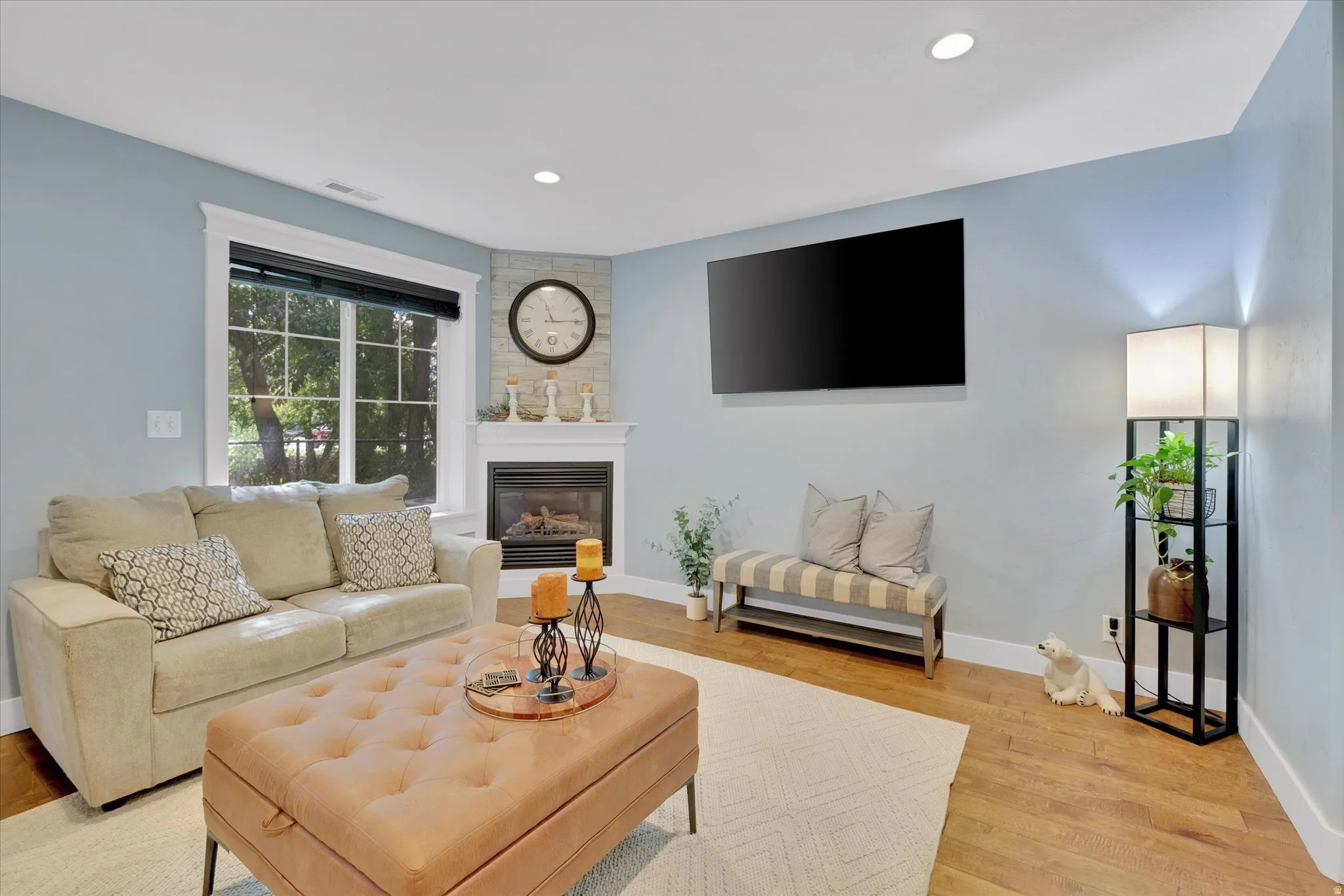 Corner fireplace with a stone-finish surround and white mantel