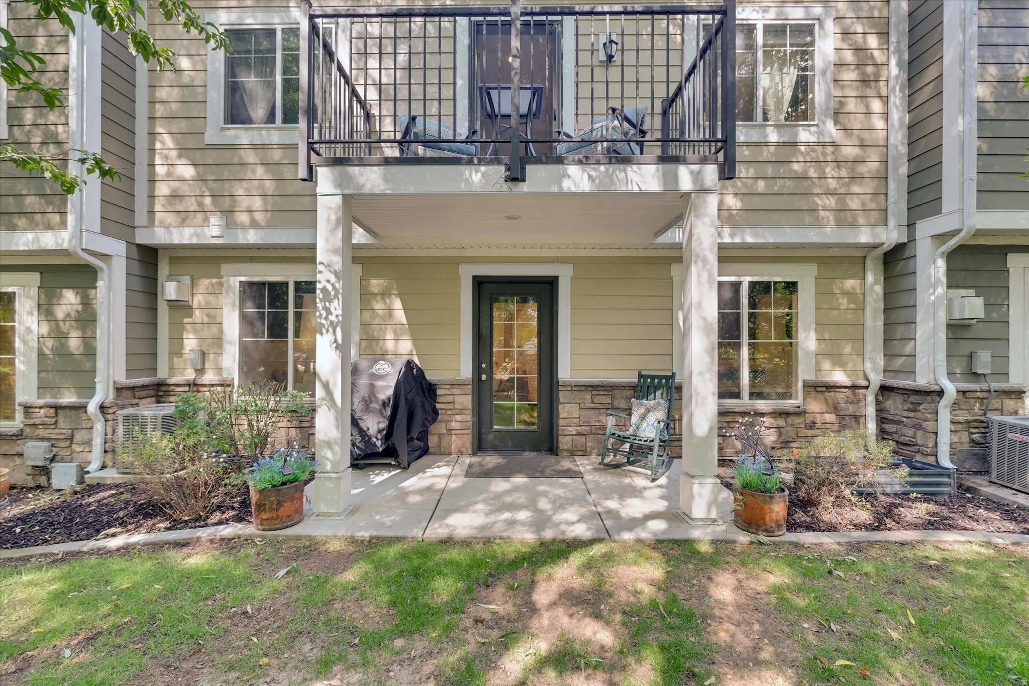 Multi-story exterior with horizontal siding and stone veneer detailing