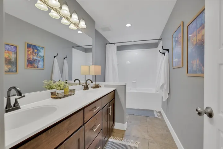 Dual vanity with wood-finish cabinetry and undermount sinks