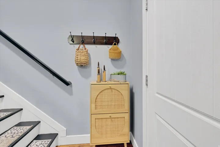 Light gray wall paint, white trim, and a black handrail