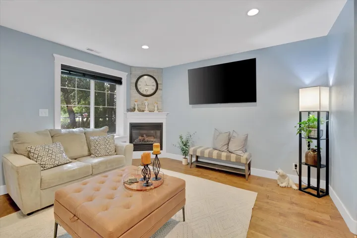 Corner fireplace with a stone-finish surround and white mantel