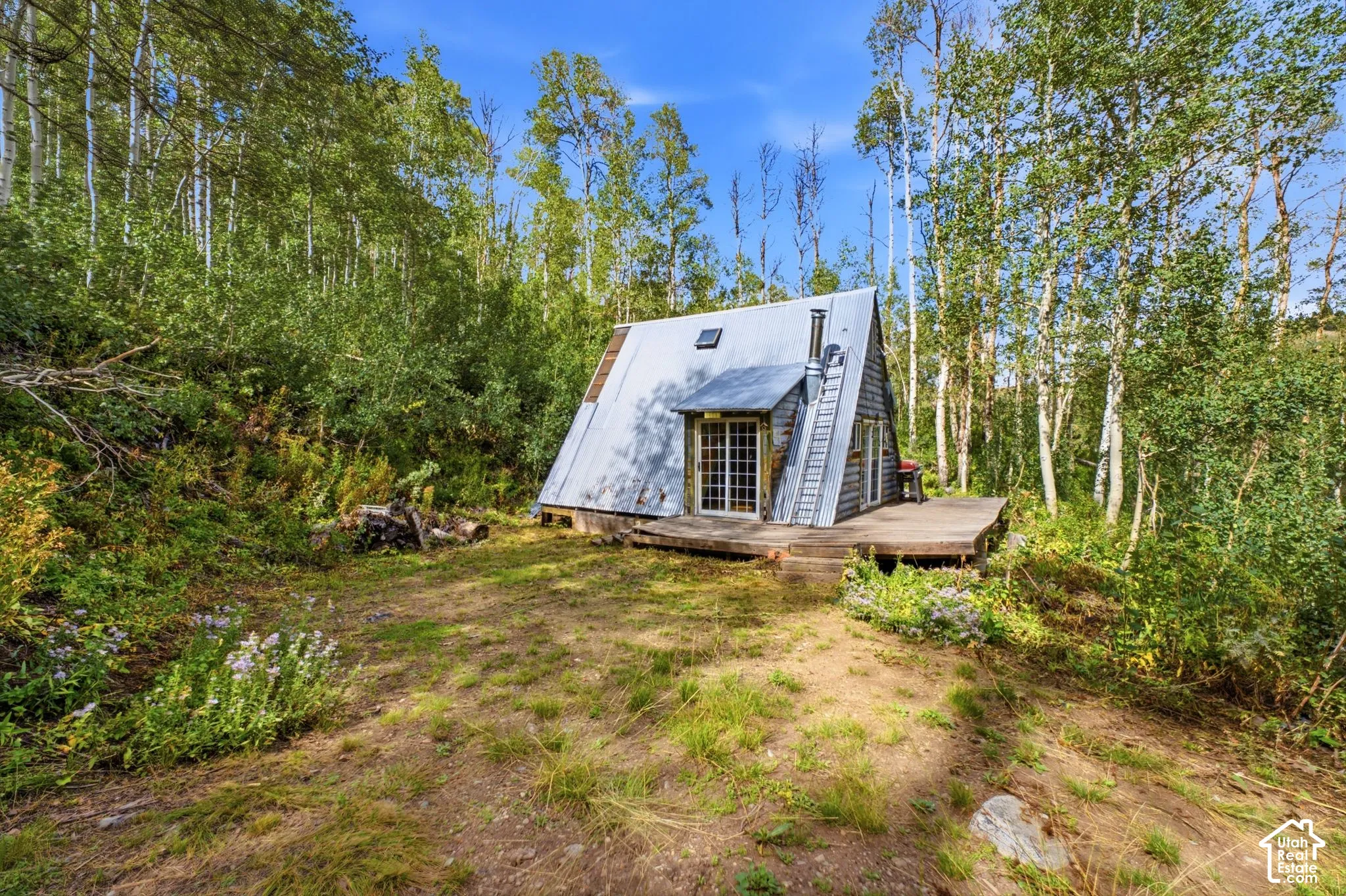 A-frame structure featuring a metal roof and a wood-slat exterior