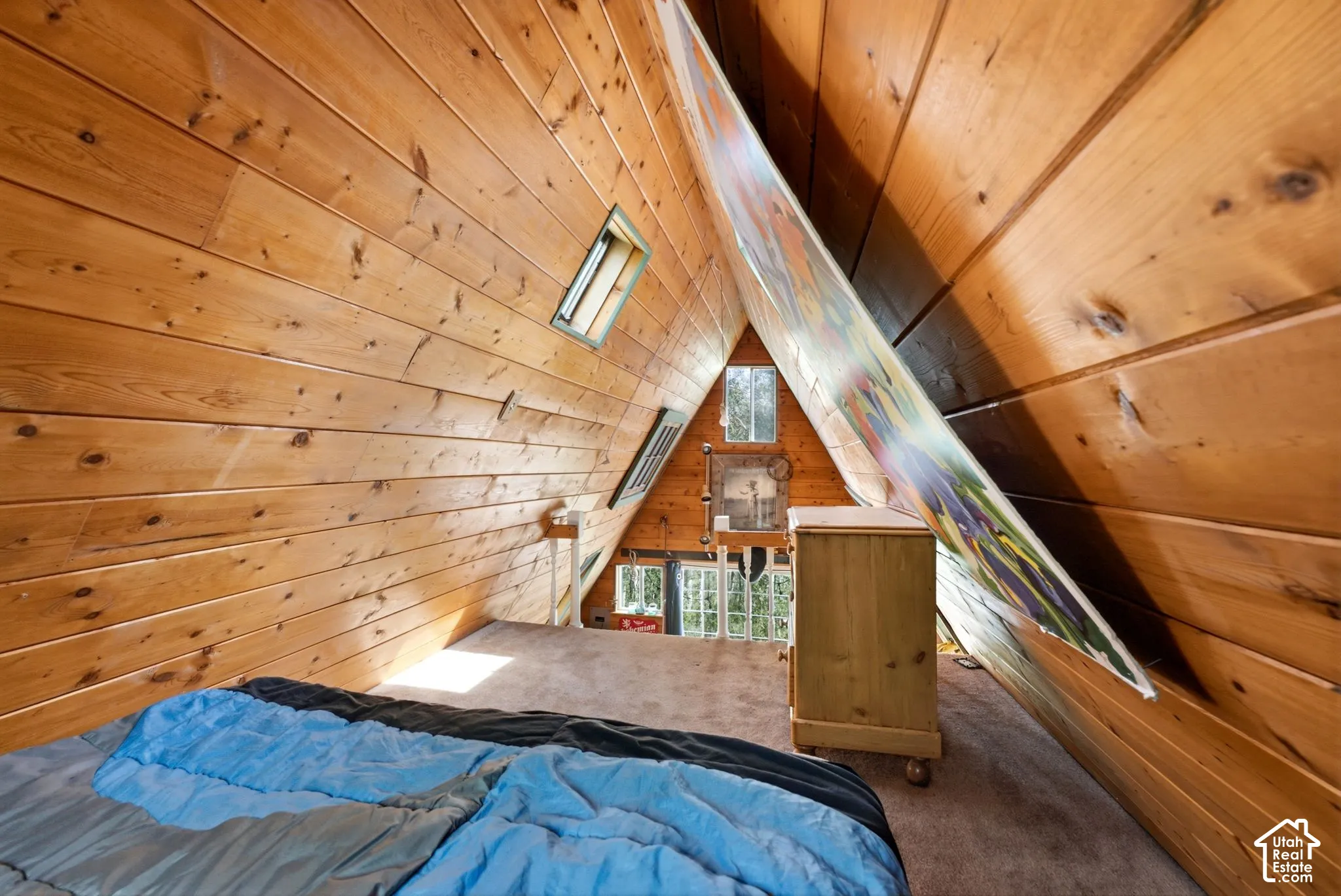 Vaulted wood-paneled walls with skylight