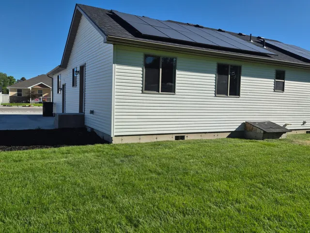 White horizontal siding exterior with a dark asphalt shingle roof