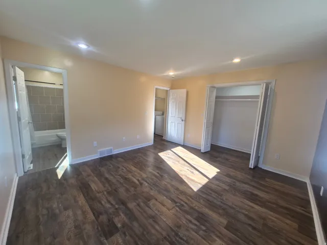 Wood-finish flooring, recessed lighting, and a built-in closet with bi-fold doors