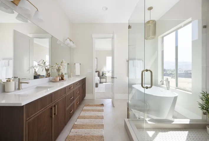 Double vanity with wood-finish cabinetry and white countertops