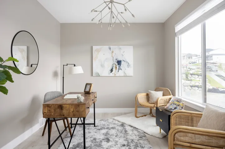 Expansive window offering abundant natural light, light wood-finish flooring, and a contemporary chandelier