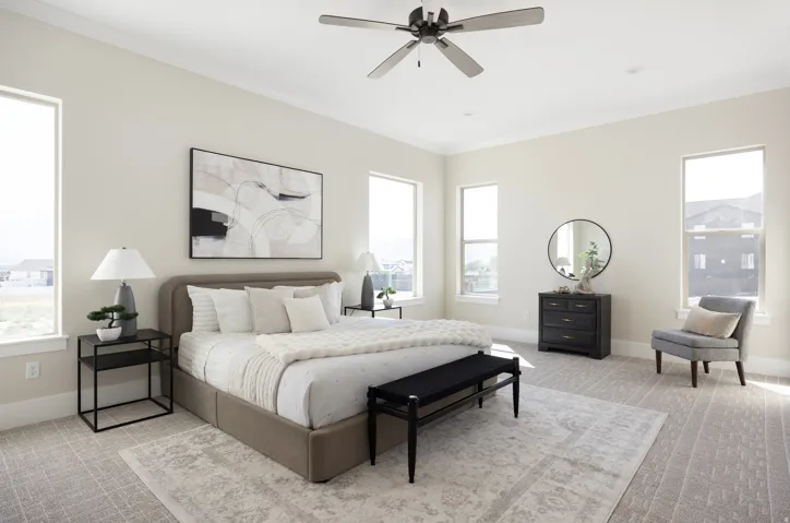 Neutral-toned walls, ceiling fan with light fixture, multiple windows, wall-to-wall carpeting, and crown molding