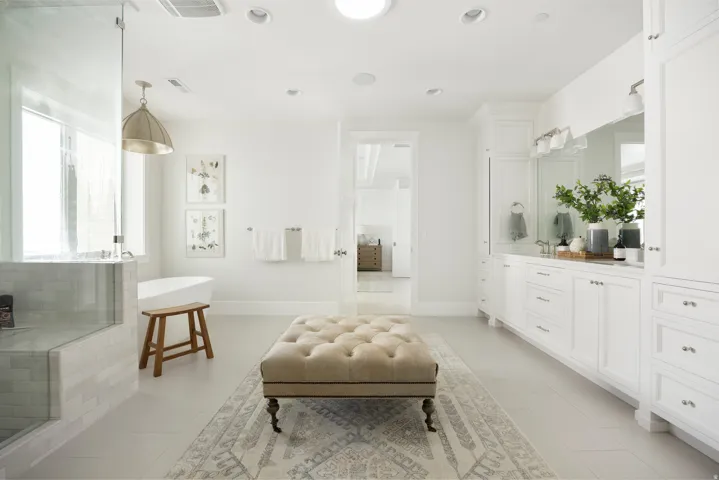 Built-in vanity with extensive storage cabinetry, integrated dual sinks, and a large mirror