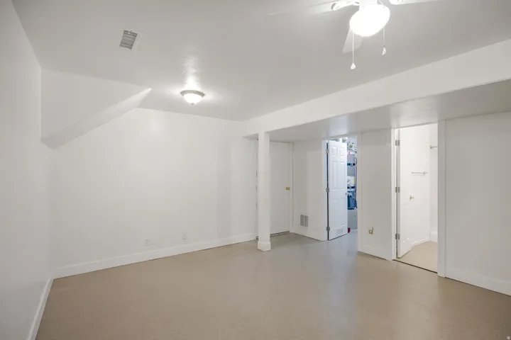 Recessed ceiling lights, white interior doors, and a ceiling fan with light fixture