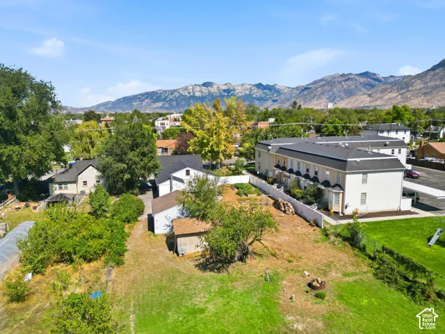 Expansive property featuring a multi-unit structure, a detached outbuilding, and mature trees
