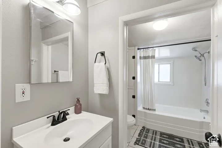 Bathroom vanity with a white countertop and a matte black faucet