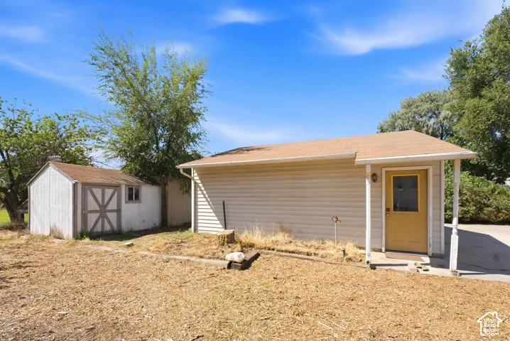 Detached auxiliary structure with siding and a covered entry