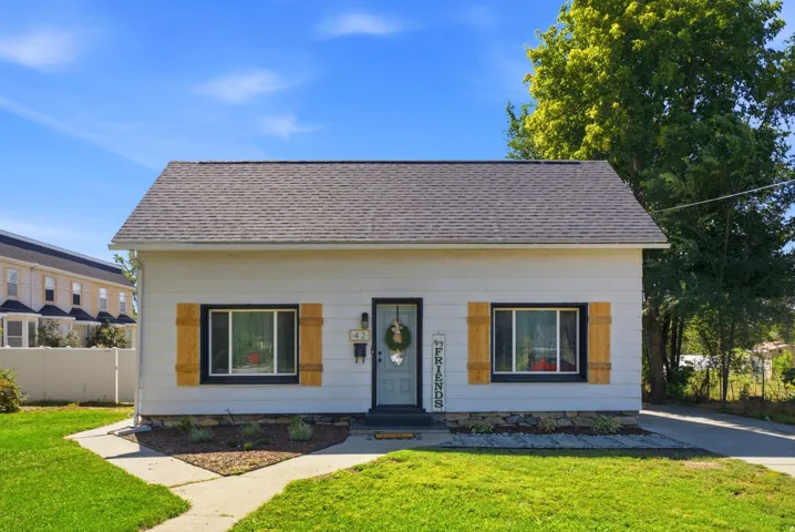 White siding exterior with a dark shingle roof