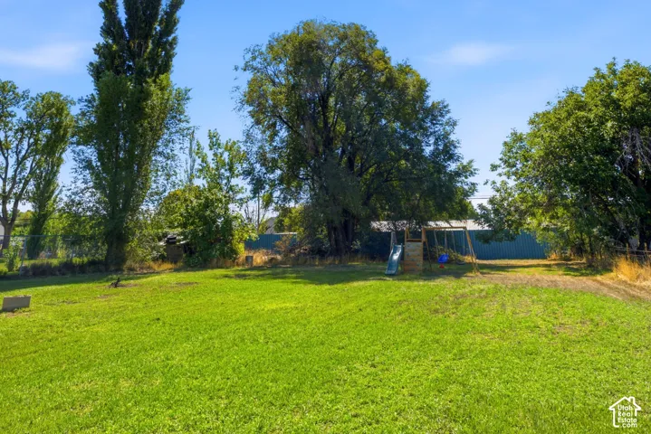 Expansive grassy yard with mature trees