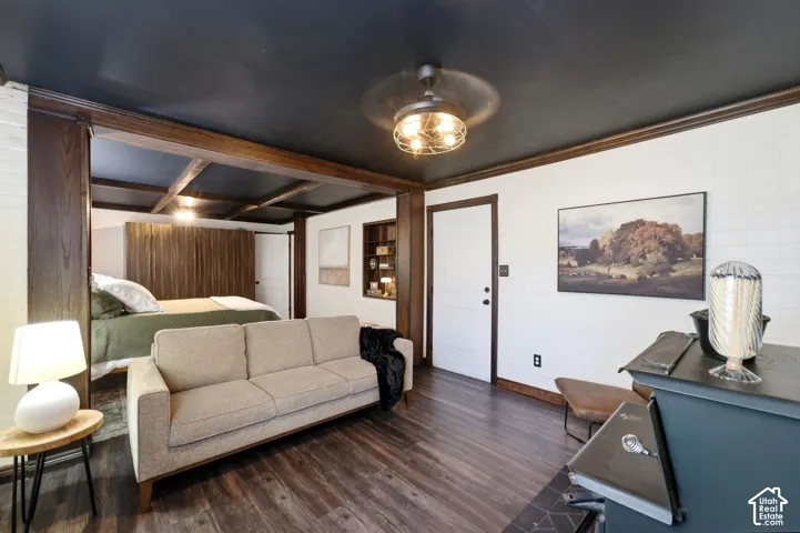 Dark wood-finish flooring with white shiplap walls and dark trim