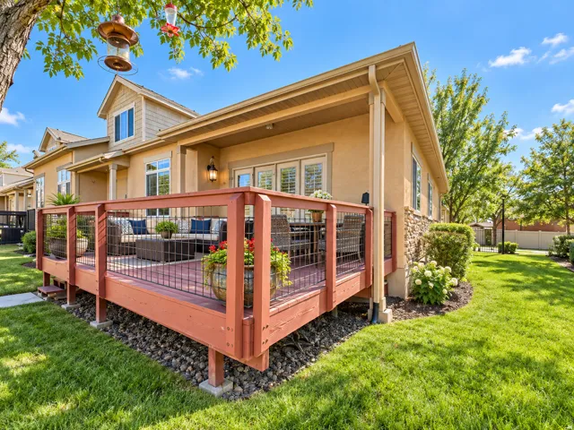Expansive rear deck with wood finish and metal railing