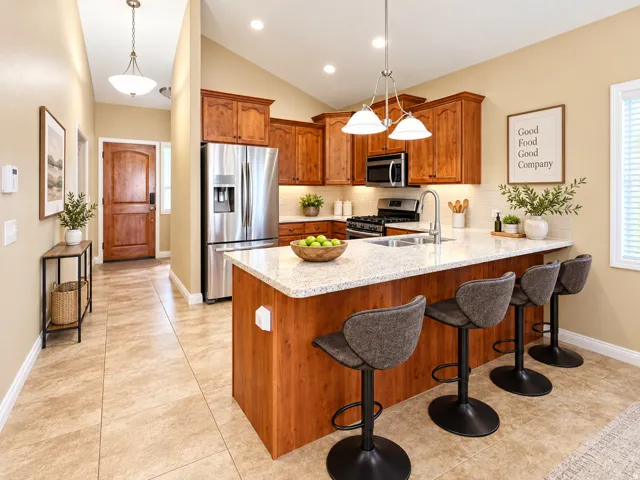 Kitchen featuring wood cabinetry, stainless steel appliances, a white tile backsplash, a large island with a light-toned countertop, and recessed lighting