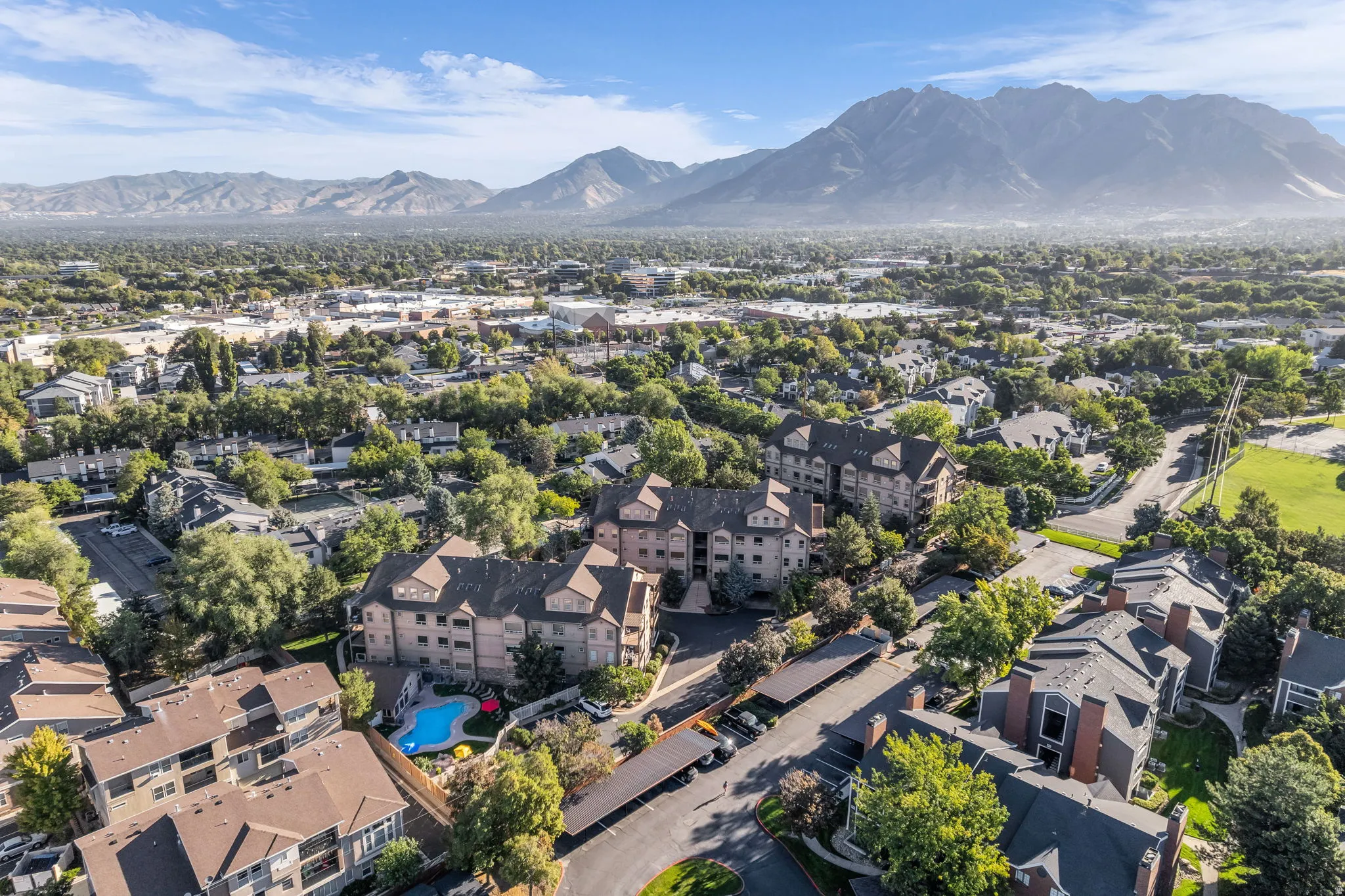 Mountain backdrop 30 min drive to Alta, Snowbird, Park City, Brighton, solitude, close to major shopping, and theaters.  Featuring multi-story residential buildings and tree-lined streets.