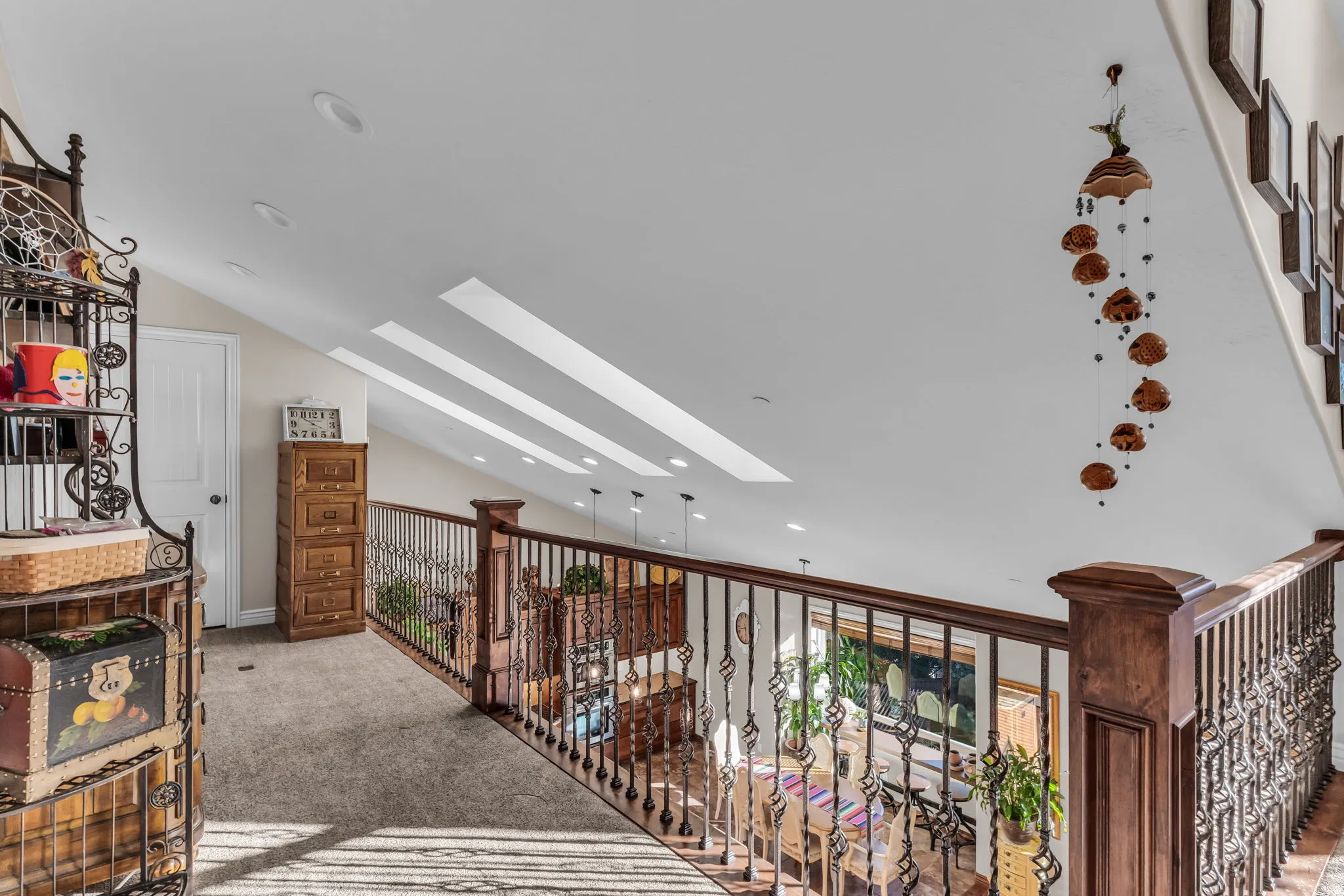 Vaulted ceilings with recessed lighting and skylights loft area