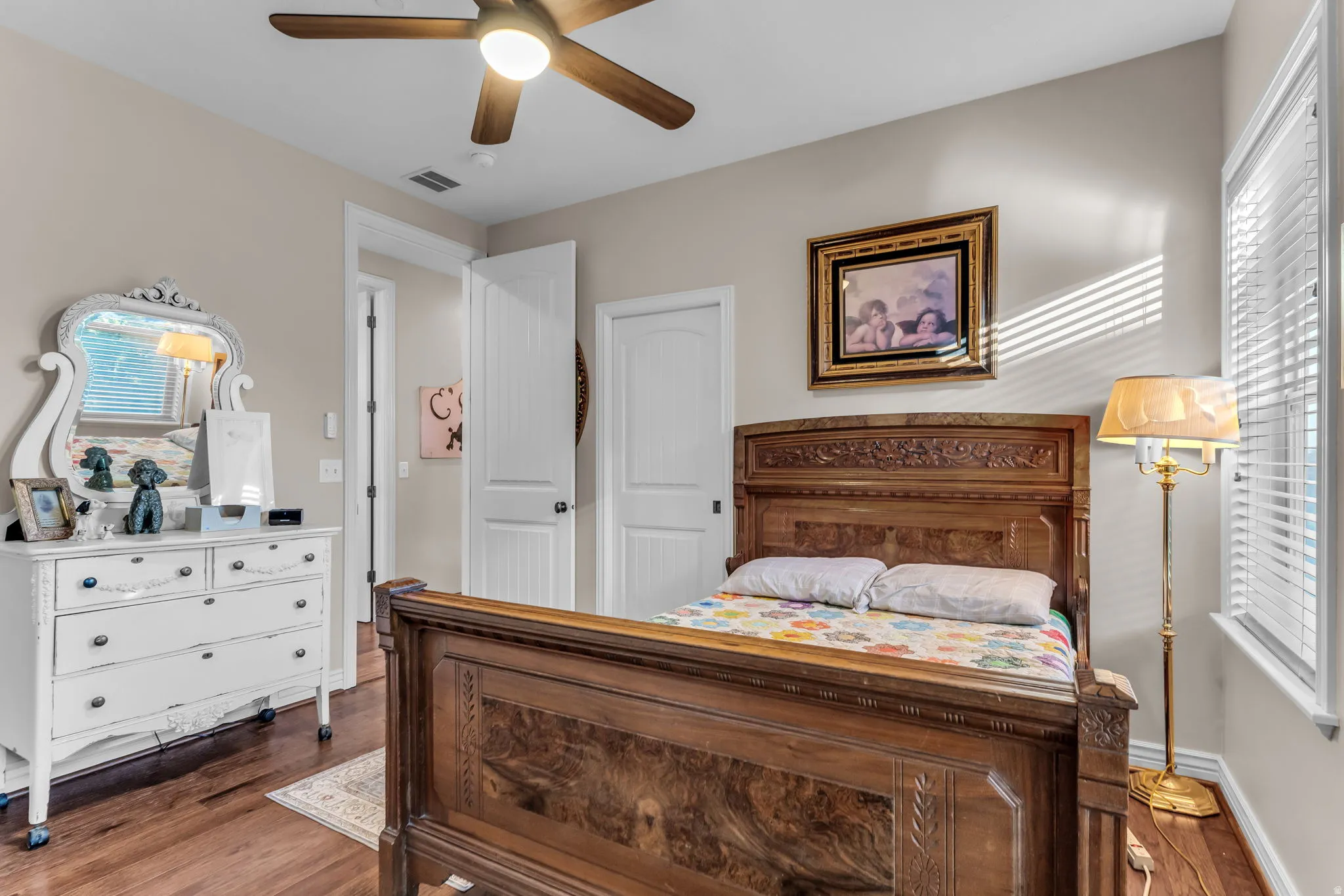 Wood-finish flooring with a ceiling fan light fixture