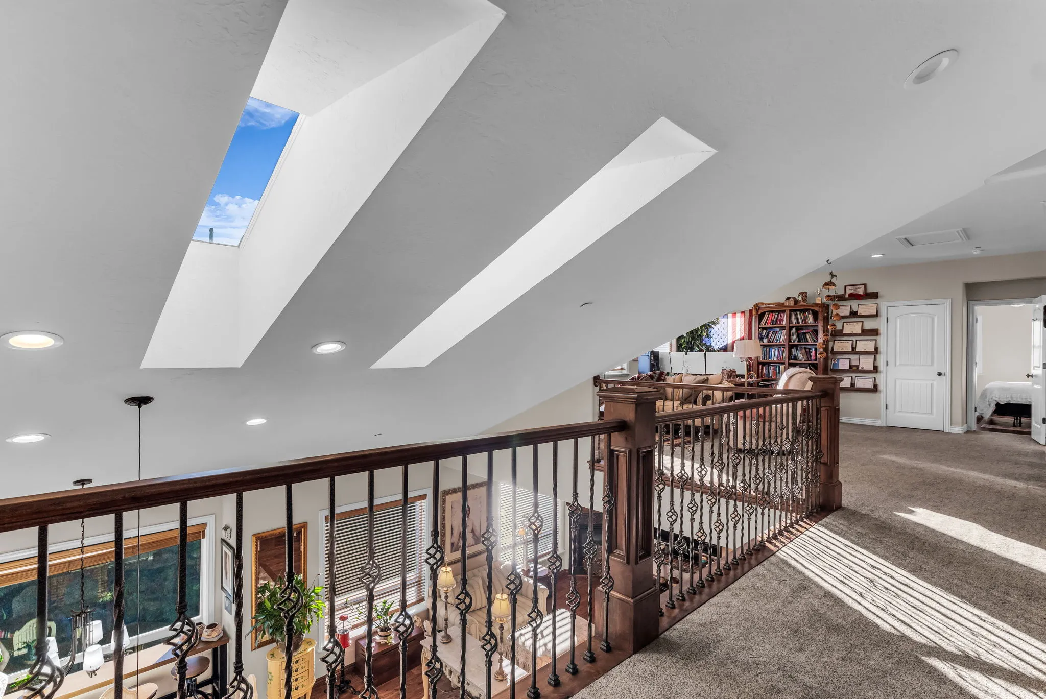 Vaulted ceiling featuring multiple skylights and recessed lighting, overlooking Kitchen and living area