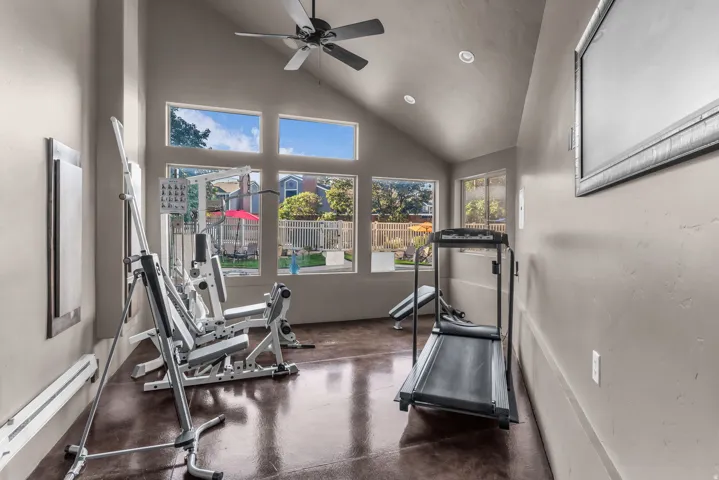 Vaulted ceiling with a ceiling fan and recessed lighting
