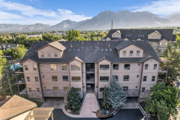 Multi-story building featuring stone and siding exterior, dormer windows, and covered parking, mountain views 4 major Ski Resorts Alta, Snowbird, Brighton and Solitude, 30 min drive