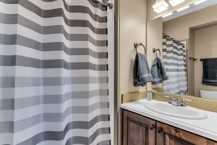 Integrated vanity with a single basin sink and dual-handle faucet