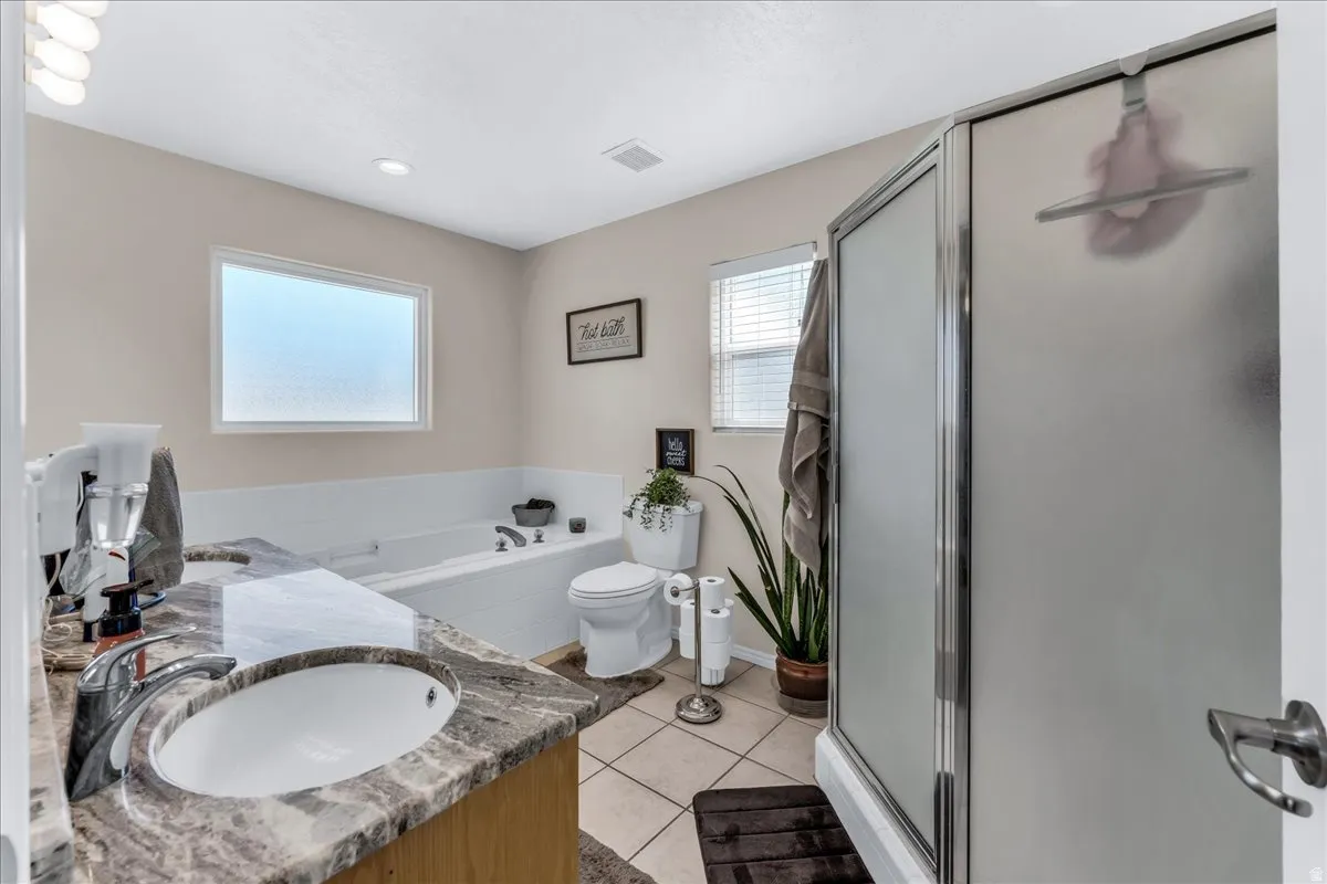 Vanity with a stone-finish countertop and undermount sink