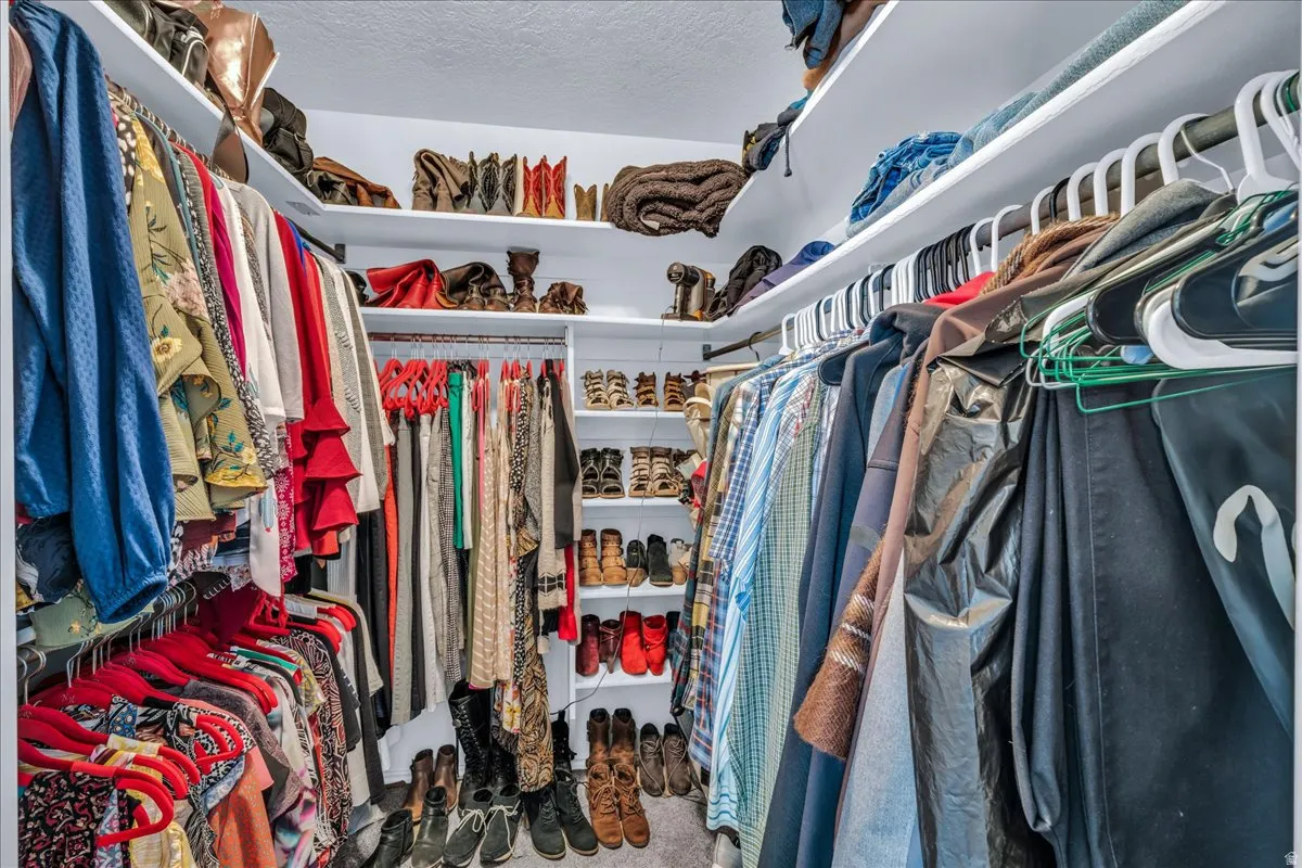 Built-in shelving, multiple hanging rods, and corner storage maximize organization