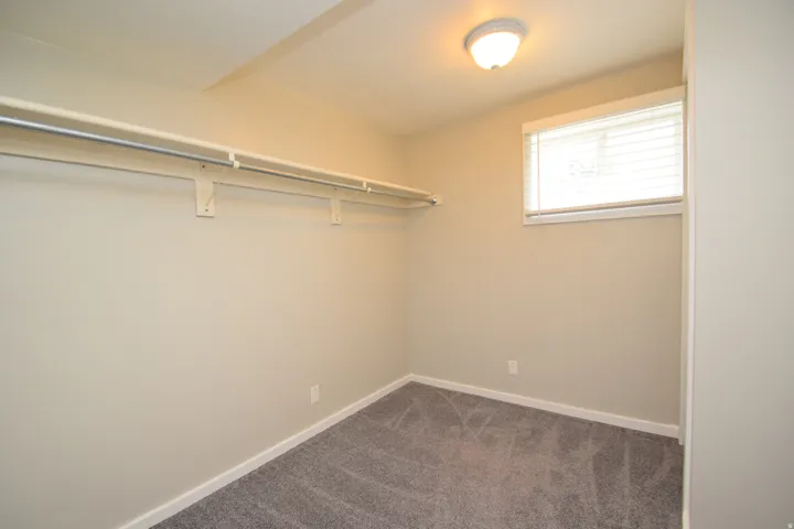 Neutral-toned walls complement the gray carpeting