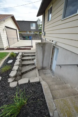 Exterior access with concrete stairs and handrail