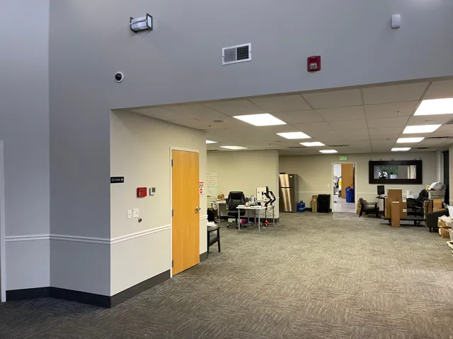 Open-concept commercial space featuring carpet flooring and recessed ceiling lighting