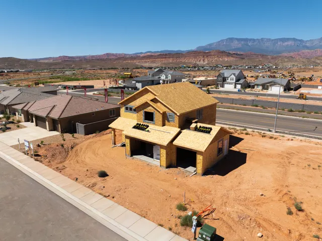 Framed structure with plywood sheathing, full roofing, and an attached garage