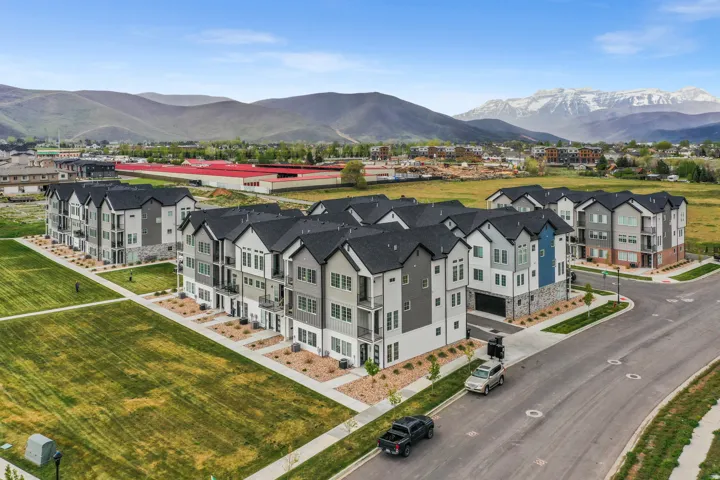 Modern townhome development with multi-story facades, balconies, and an integrated garage