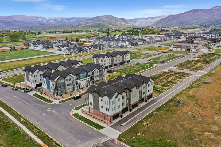 Modern townhome community featuring multi-level residences with attached garages and contemporary facades