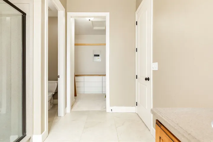 Light-toned flooring, neutral wall paint, and white trim throughout
