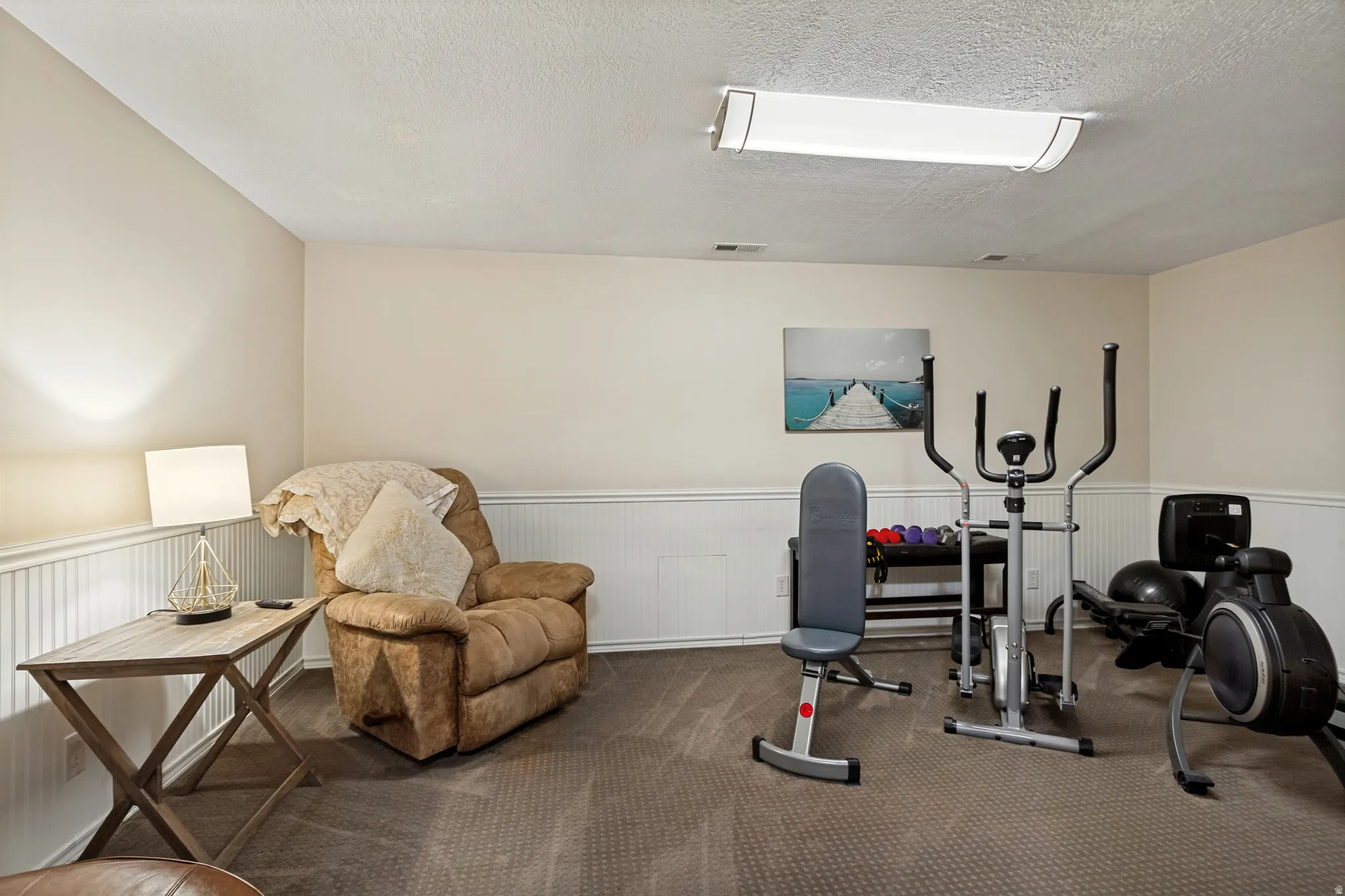 Finished Basement Recreation Room featuring neutral carpeting, recessed ceiling lighting, and wainscoting detail