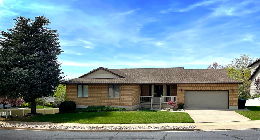 Brick exterior with a gabled roof and attached two-car garage