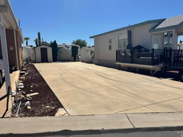 Expansive concrete parking area with integrated wood chip landscaping