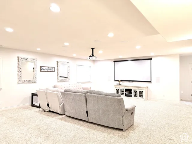 Recessed ceiling lighting, wall-mounted projector, retractable screen, built-in entertainment console, and wall-mounted speakers