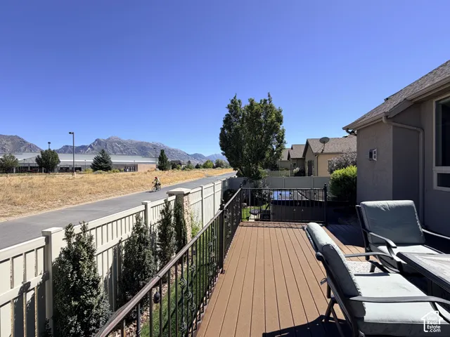 Composite decking with a metal railing and mountain backdrop