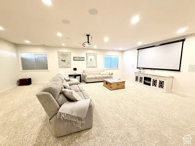 Recessed lighting, ceiling-mounted speakers, projection screen, and a ceiling-mounted projector