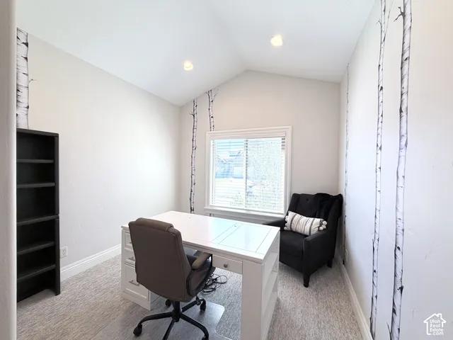 Vaulted ceiling featuring recessed lighting, a window with horizontal blinds, and light-toned carpeting
