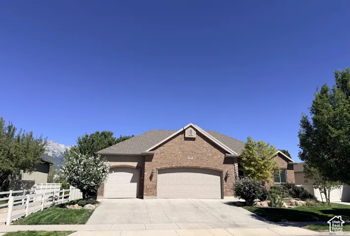 Brick exterior with a gabled roof and arched garage doors