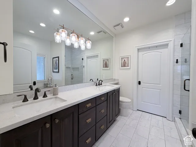 Dual vanity with dark wood cabinetry and light stone countertops